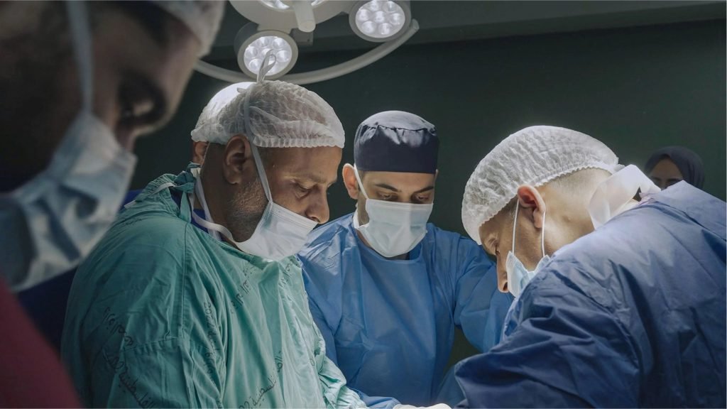 Surgeons operating in theatre